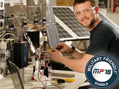 Jordon Williams at the solar lab, Military Friendly Schools 2016 logo in corner