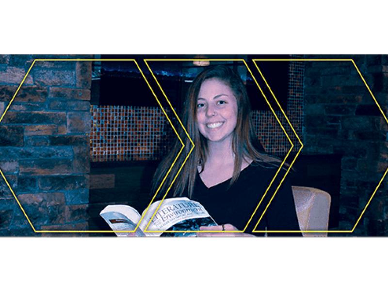 Mackenzie Congdon holding a book open