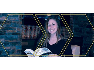 Mackenzie Congdon holding a book open