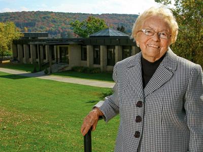Mary Huntington in front of the Huntington Adminstration building