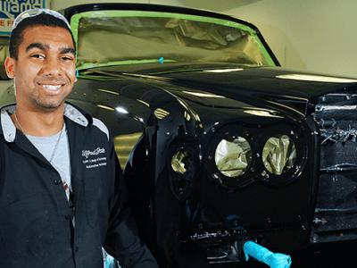 Ryan in front of a car