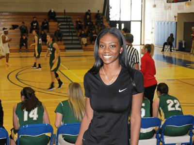 Tatyana in gymnasium with basketball game in background
