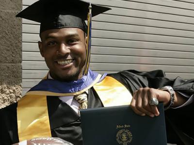 Thomas Daniels holding diploma