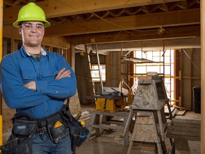 Travis Harvey in a construction zone wearing a hard helmet