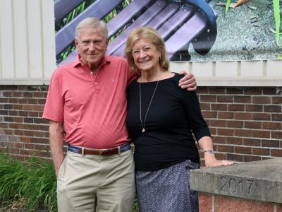 Tom and Dottie Kelsey stand outside the Wellsville campus