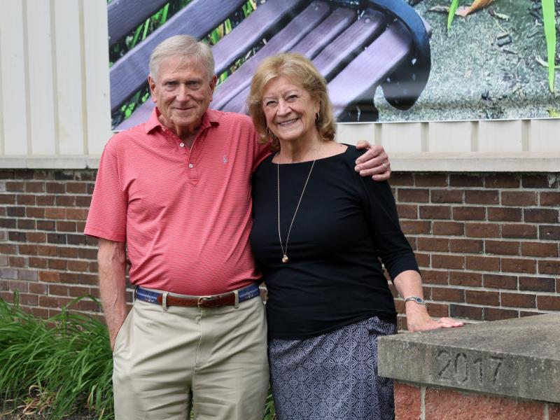 Tom and Dottie Kelsey stand outside the Wellsville campus