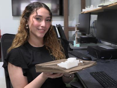 student holds an architectural model