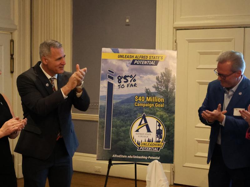 Dr. Mauro celebrates the unveiling of the comprehensive campaign progress.