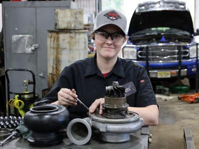 student works on an autopart