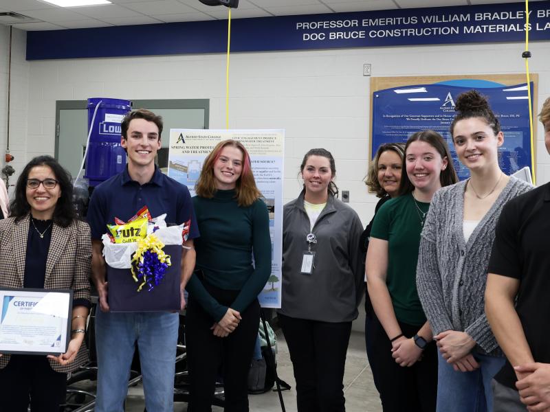 Students pose with their prize for winning a water treatment contest