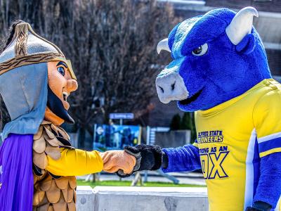Mascots shake hands in downtown Alfred.