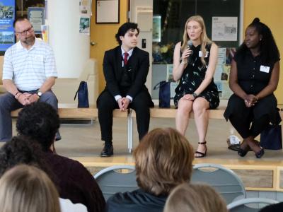 Leyah speaks with current students at a networking event.