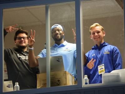 Will Rollison along with a pair of students in the pressbox