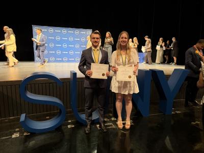 students showing certificates after being honored by Chancellor