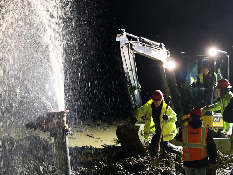 Students work on water main break