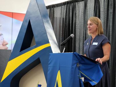 Jennifer Noble stands at the podium