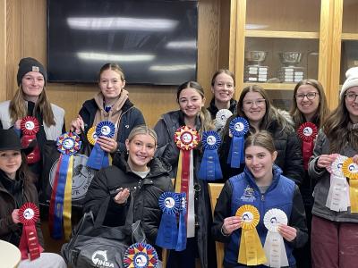 Athletes pose with awards