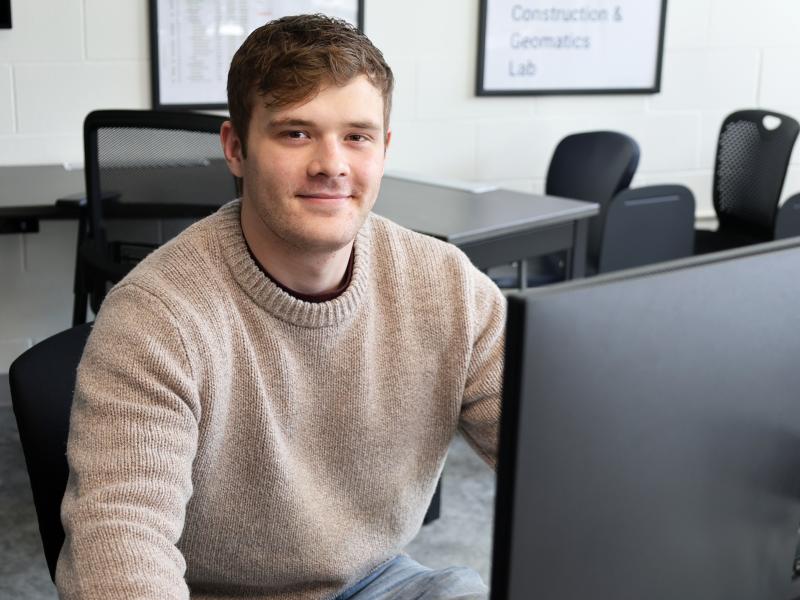 student sits in front of a computer!