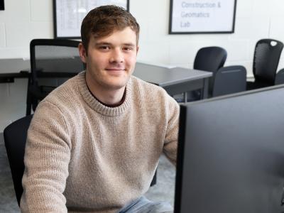 student sits in front of a computer!