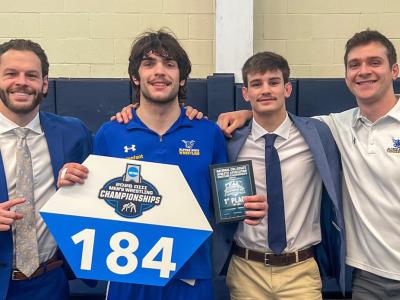 Sean Malenfant stands with his coaches.