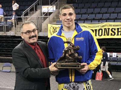 Ian Van Valen receives his Most Outstanding Wrestler award