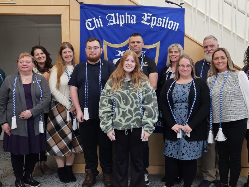 The 2026 Class of Chi Alpha Epsilon poses with faculty and staff.