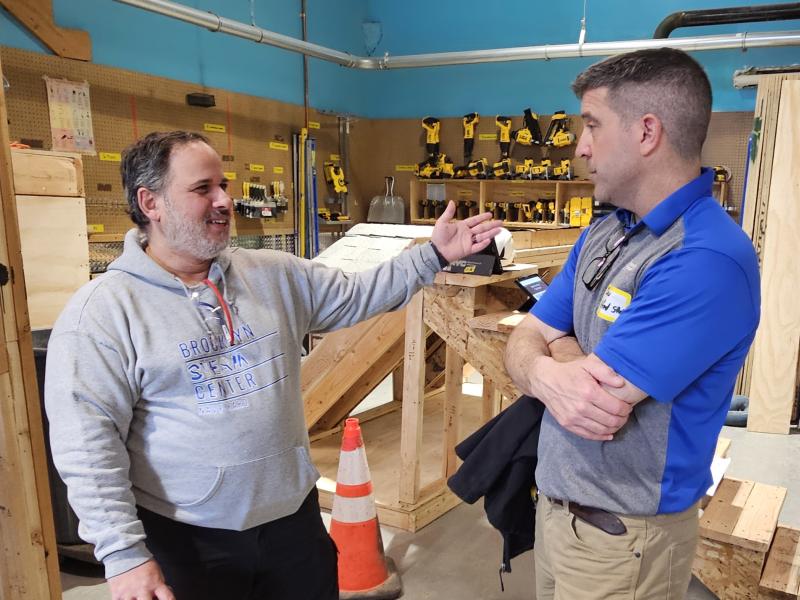 A teacher speaks with ASC Building Trades Chair Dan Helveston at an event at the Brooklyn STEAM Center