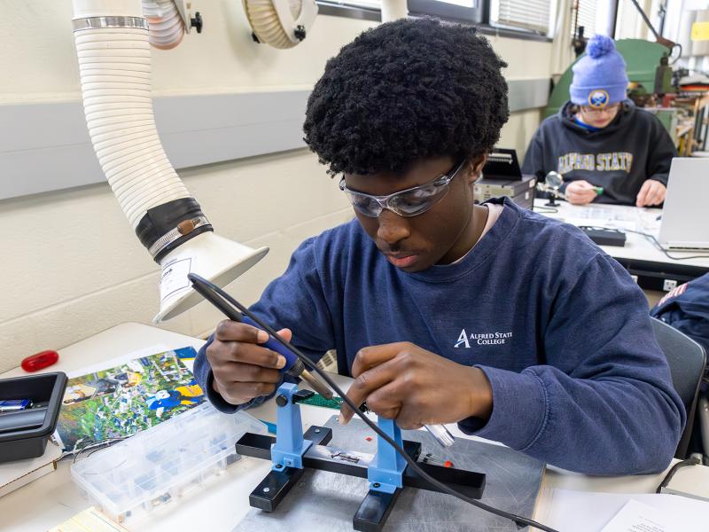 student works on an engineering project in a lab