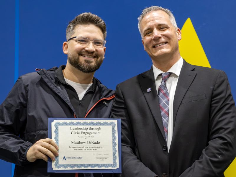 Matt DiRado stands with President Mauro after receiving the Leadership through Civic Engagement Award.