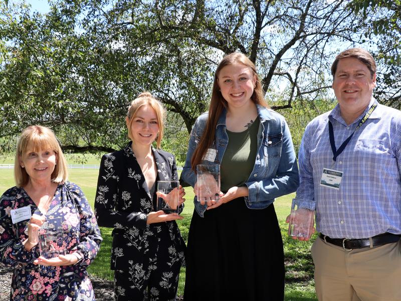 four individuals stand with the awards they were presented at the Alumni Brunch