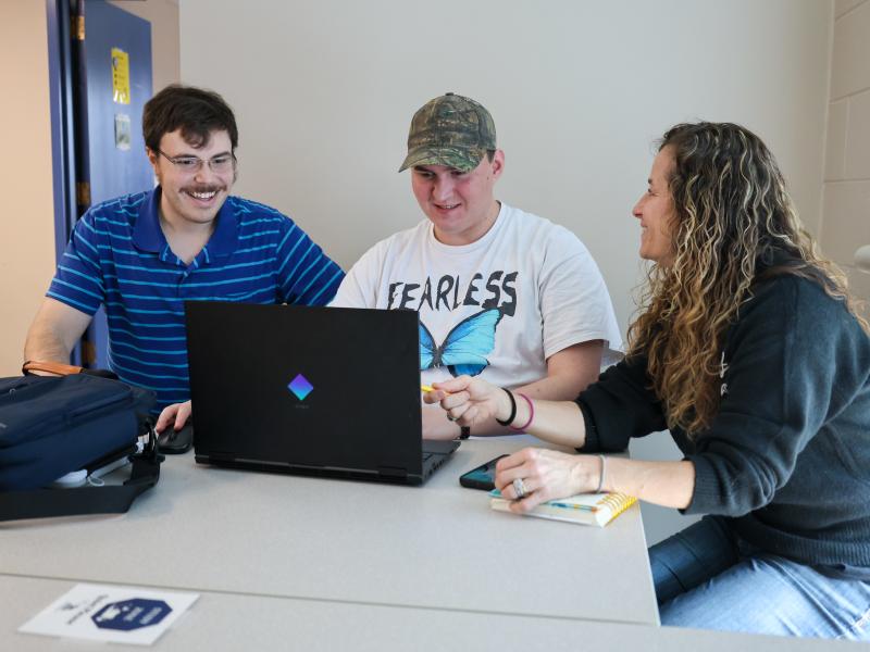 student works with a pair of student success coaches
