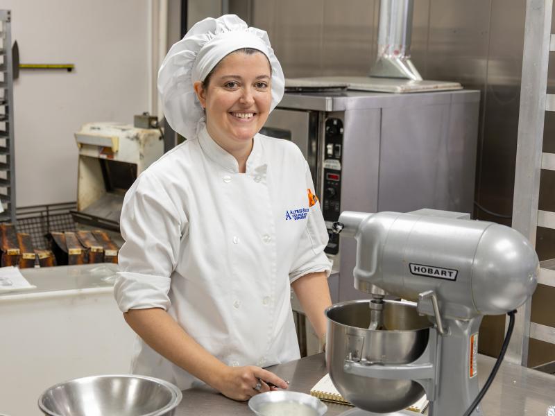 bakery student works on a cake