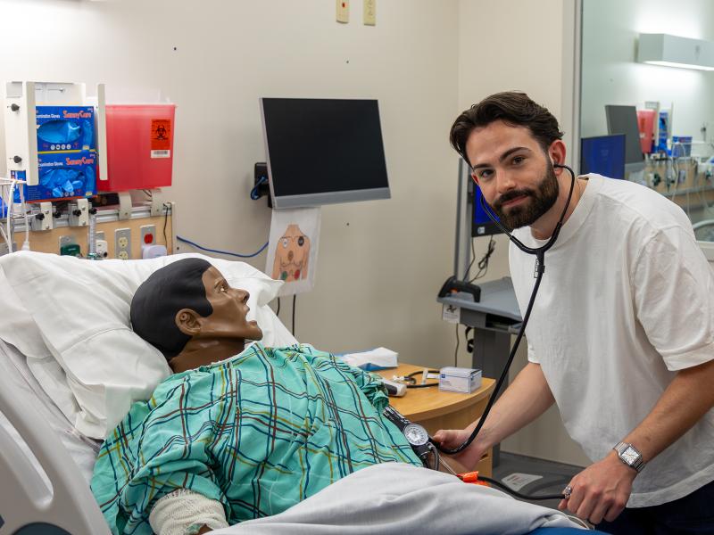 nursing student works in a simulation lab