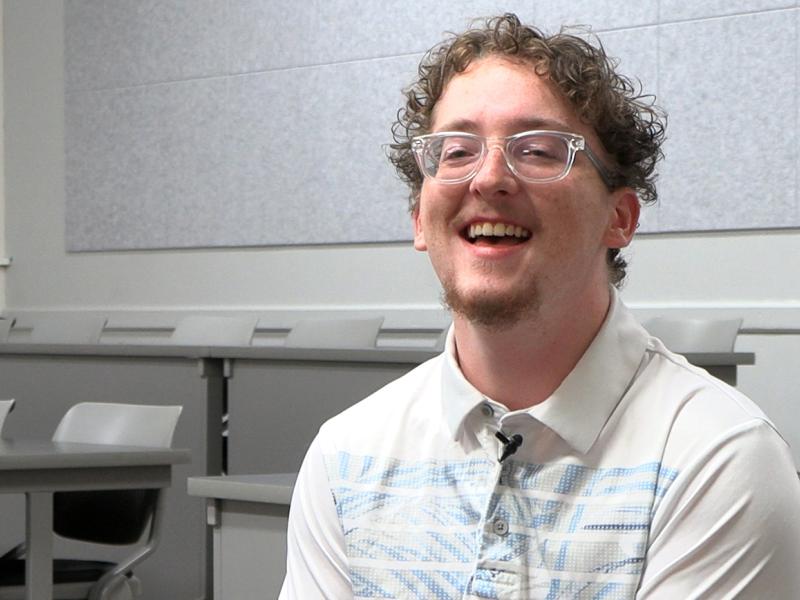 student laughing in a classroom