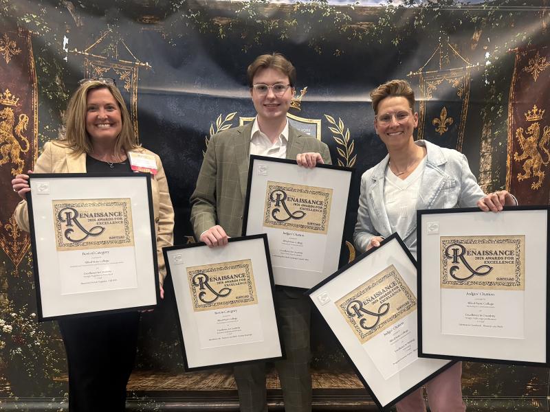 A group of ASC employees displays awards