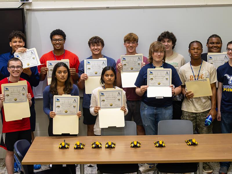 students show off their certificates from robotic camp