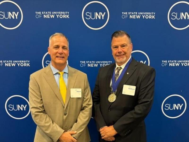 William Dean stands with Dr. Mauro after receiving the SUNY Distinguished Professor Designation