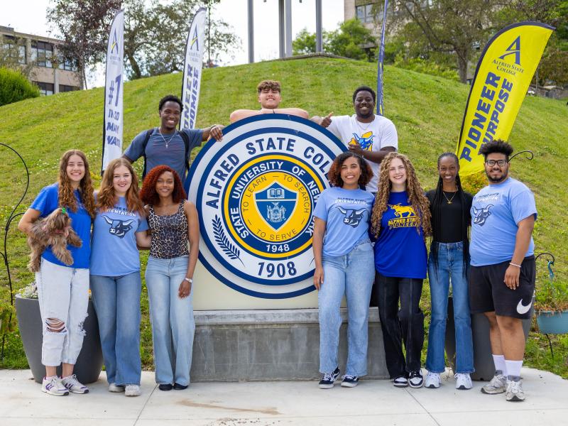 smiling students at the college seal