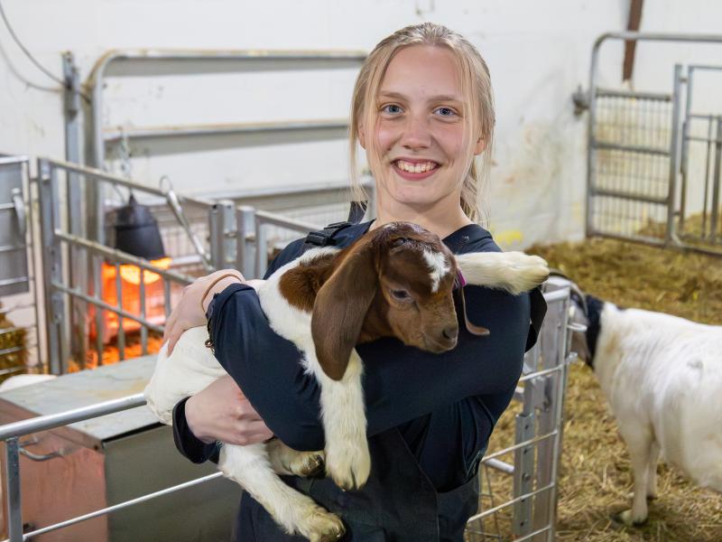 student holds an animal