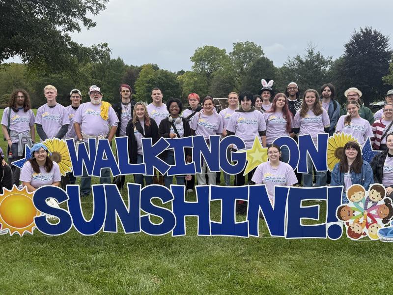students pose after participating in the Walking on Sunshine fundraiser