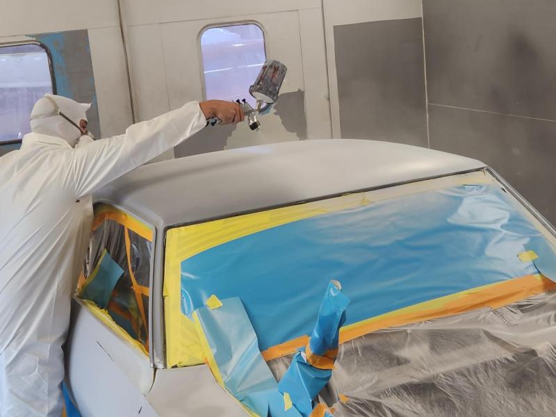 An Alfred State student works on the paint job for the 1969 Pontiac Firebird Trans Am.