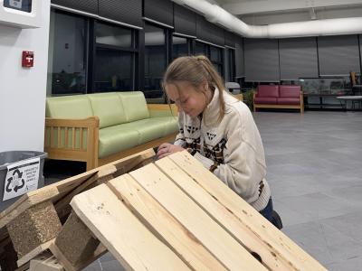 Jordan Henry works on a enrichment tool for the dogs