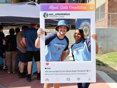 Orientation leaders with an Instagram post sign.