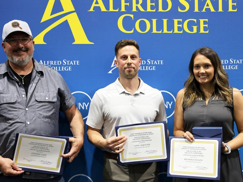 Advising award honorees display awards
