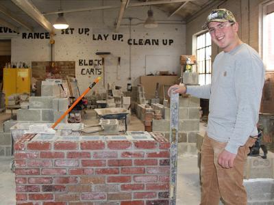A masonry student works on a project at the School of Applied Technology. Masonry is one of several academic programs in the school ranked highly by US News & World Report.