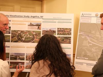 students speak with locals after making an architecture presentation
