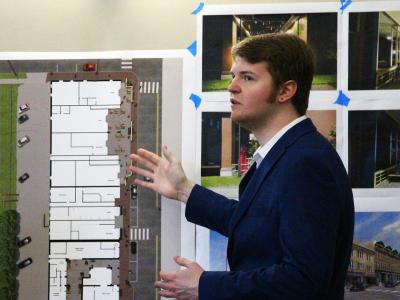 An architecture student presents his project on the redesigning of the Village of Alfred downtown business area.