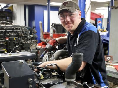 student works in the auto shop
