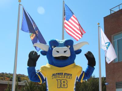 Alfred State’s mascot Big Blue is ready to show the chancellor how the Pioneers are “strong as an ox” when Chancellor King visits Alfred.