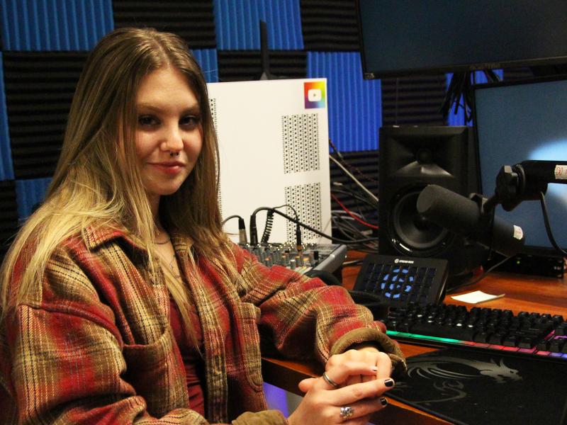 Students sits in the recording studio